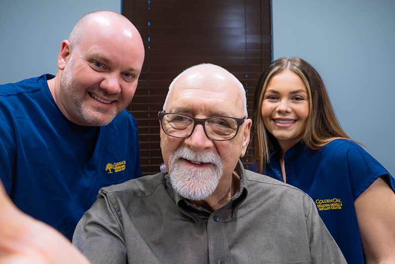 Dr. Shanks, a staff member and patient smiling